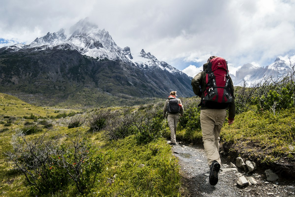 Trekkers on mountain trail at sunrise