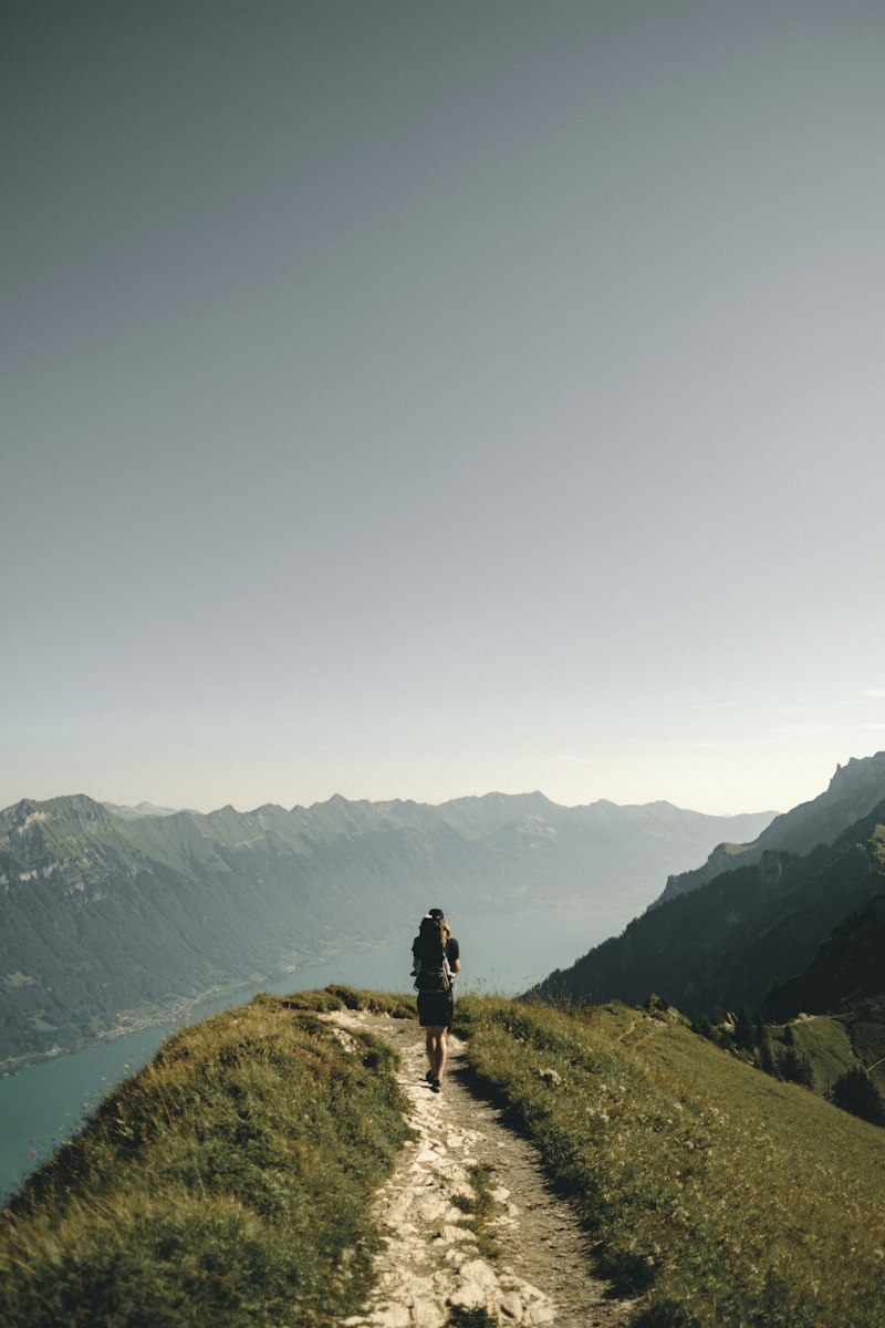 Hiker with backpack looking at mountains